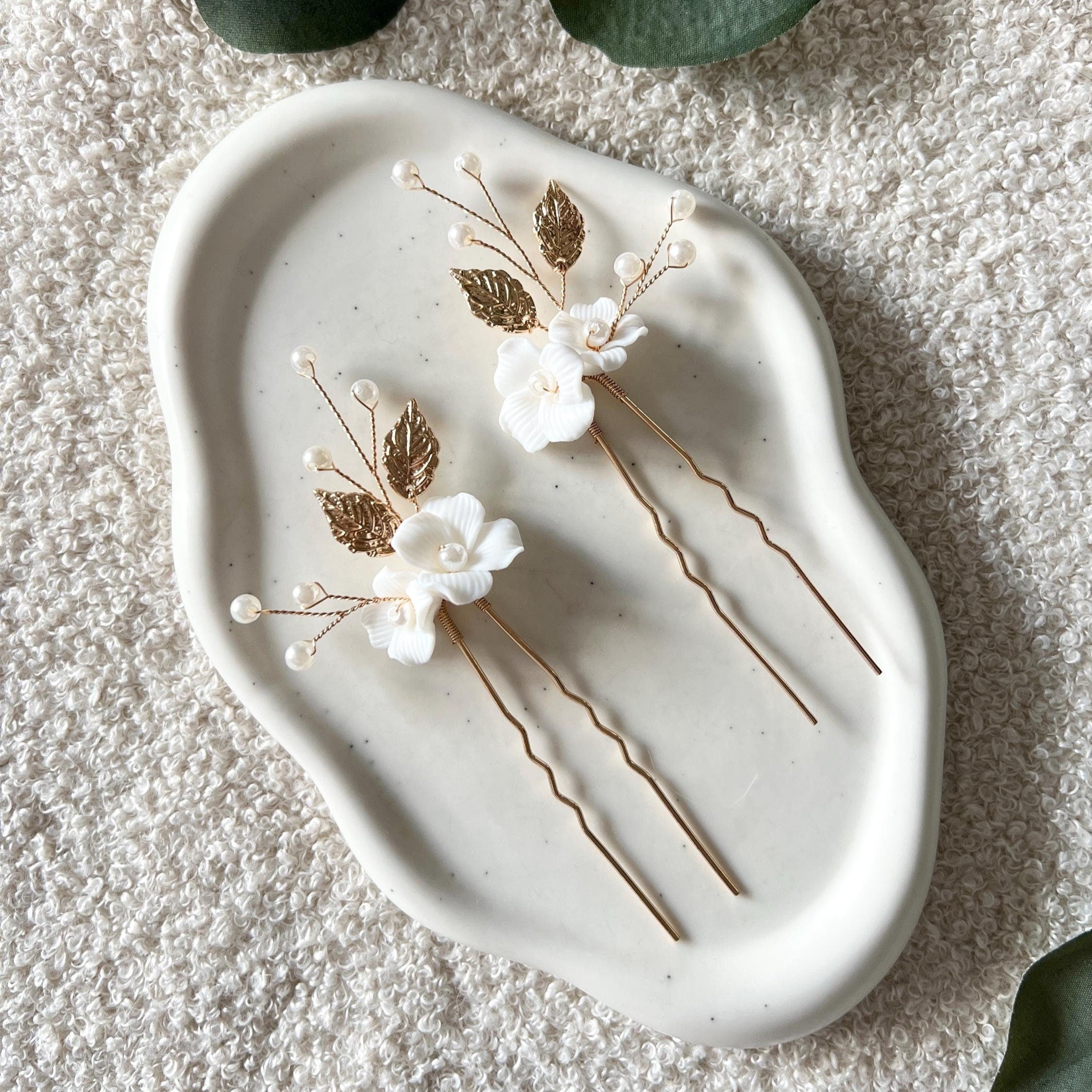 Feine Haarnadeln, Set 2 Stueck, Blumen aus Keramik, feiner goldener Schmuck, Haarschmuck fuer die Brautfrisur, weisser Bluetenschmuck, zarte Perlen und Strasssteine, eleganter Brautschmuck, moderner Perlenschmuck, luxurioeser Brauthaarschmuck, Perlenhaarschmuck, hochwertiger Hochzeitsschmuck, Schmuck Hochzeit, Weddinginspiration