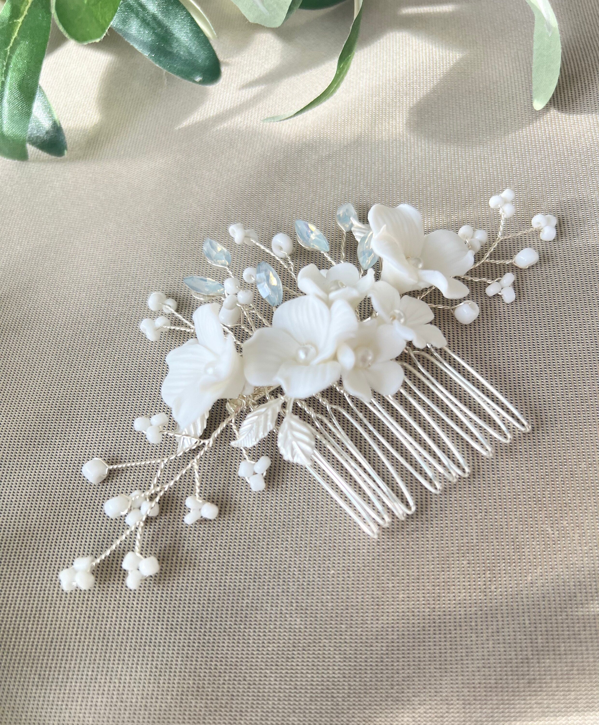 Haarkamm, Brautschmuck, feiner Brauthaarschmuck, Silber, Keramikblueten, weiße Porzellanblumen, Haarschmuck mitweissen Perlen, Perlenschmuck Hochzeit, Hochzeitsschmuck, blaeuliche Strasssteine_ Brautfrisur_Schmuckbluete